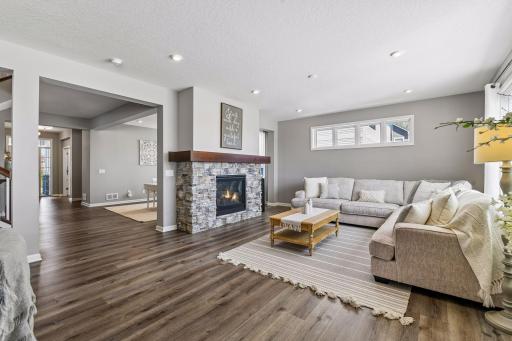 Large family room on the main floor with stacked stone gas fireplace flows seamlessly into the rest of the main level.