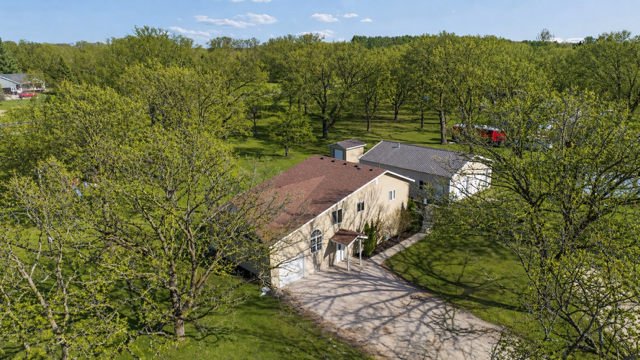 Welcome home to sprawling beauty and privacy! Over an acre of mature trees, fenced yard, and maint free exterior! **photo digiatlly enhanced