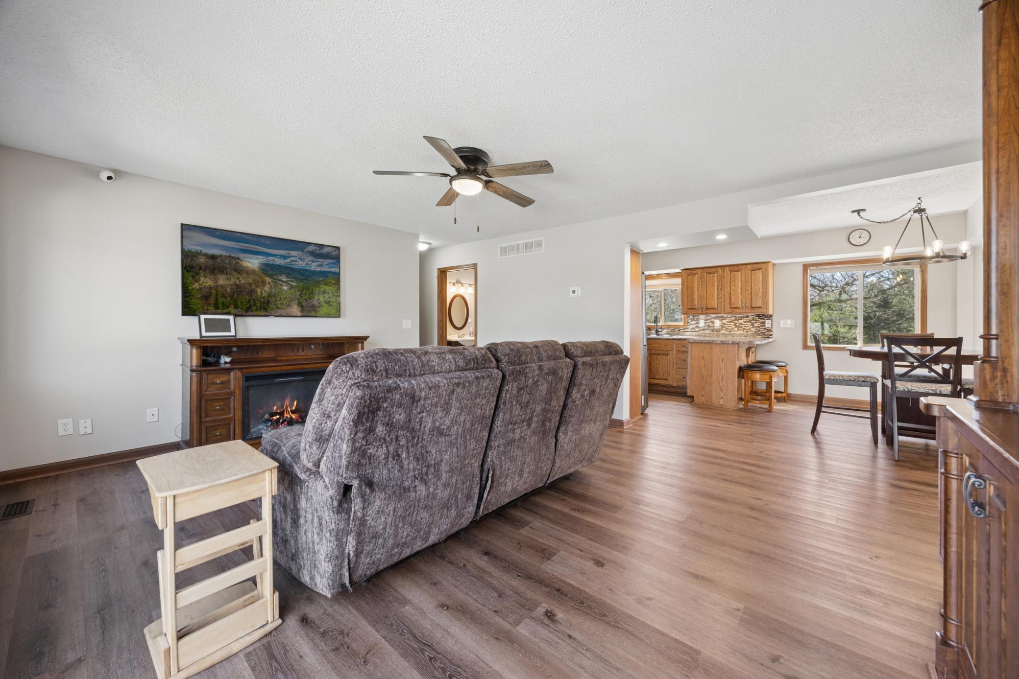 Large living room area offers LVP flooring, fresh paint, and is open to the kitchen and dining area