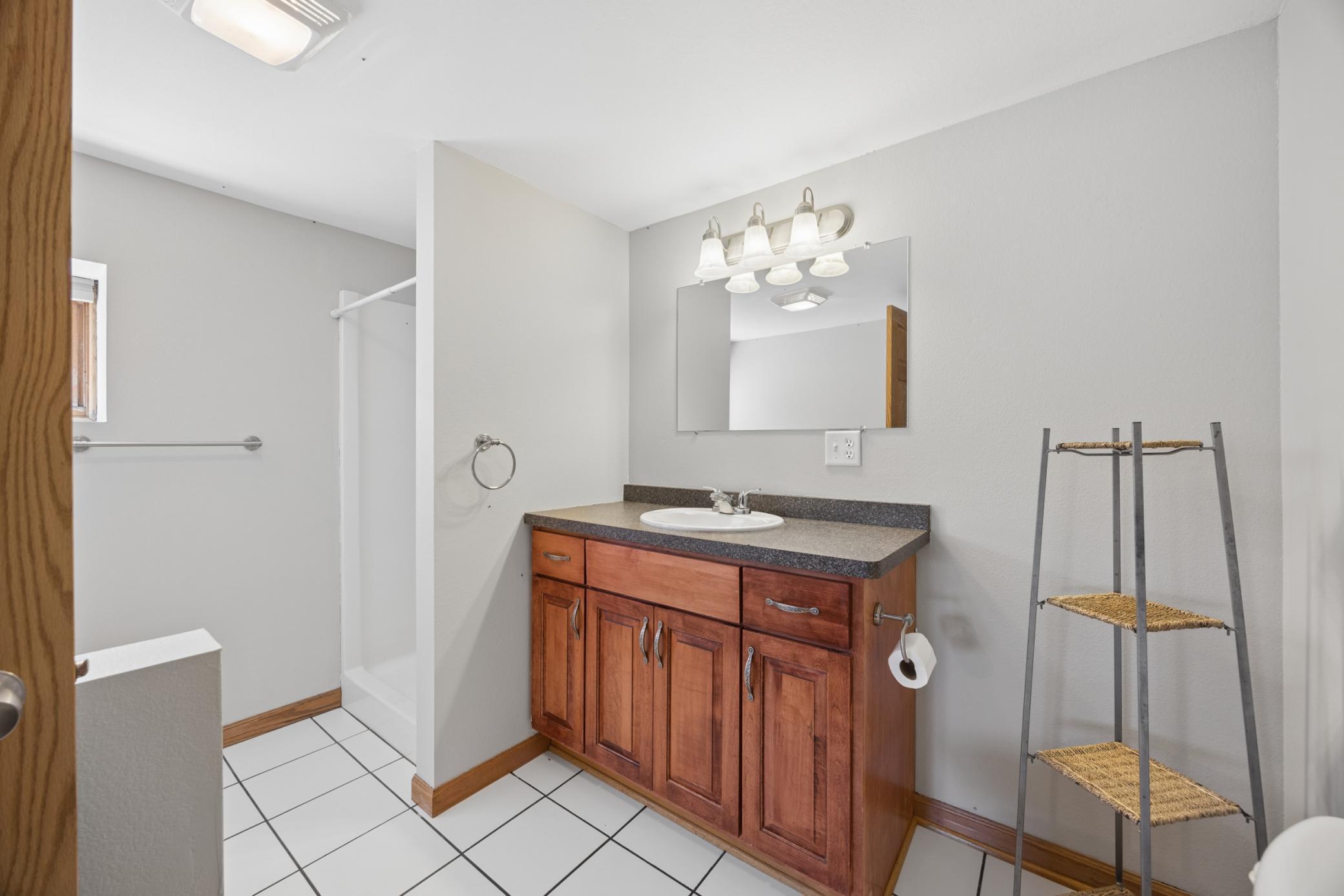 Lower/main full bath boasts fresh paint and tile flooring