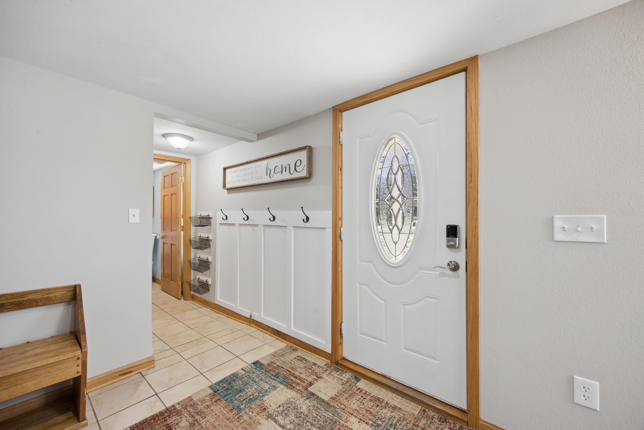 You are welcomed in by this spacious entry, complete with tile floors, coat hooks, entry closet, and fresh paint!