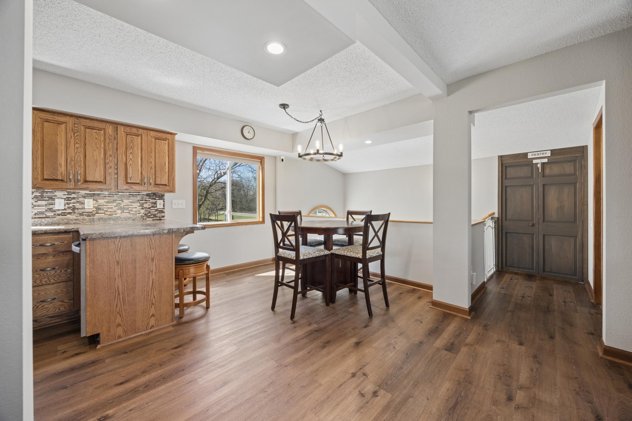 Upper level offers LVP flooring, updated lighting, fresh paint throughout, and wonderful natural lighting! Open kitchen, dining and living room space is perfect for entertaining!