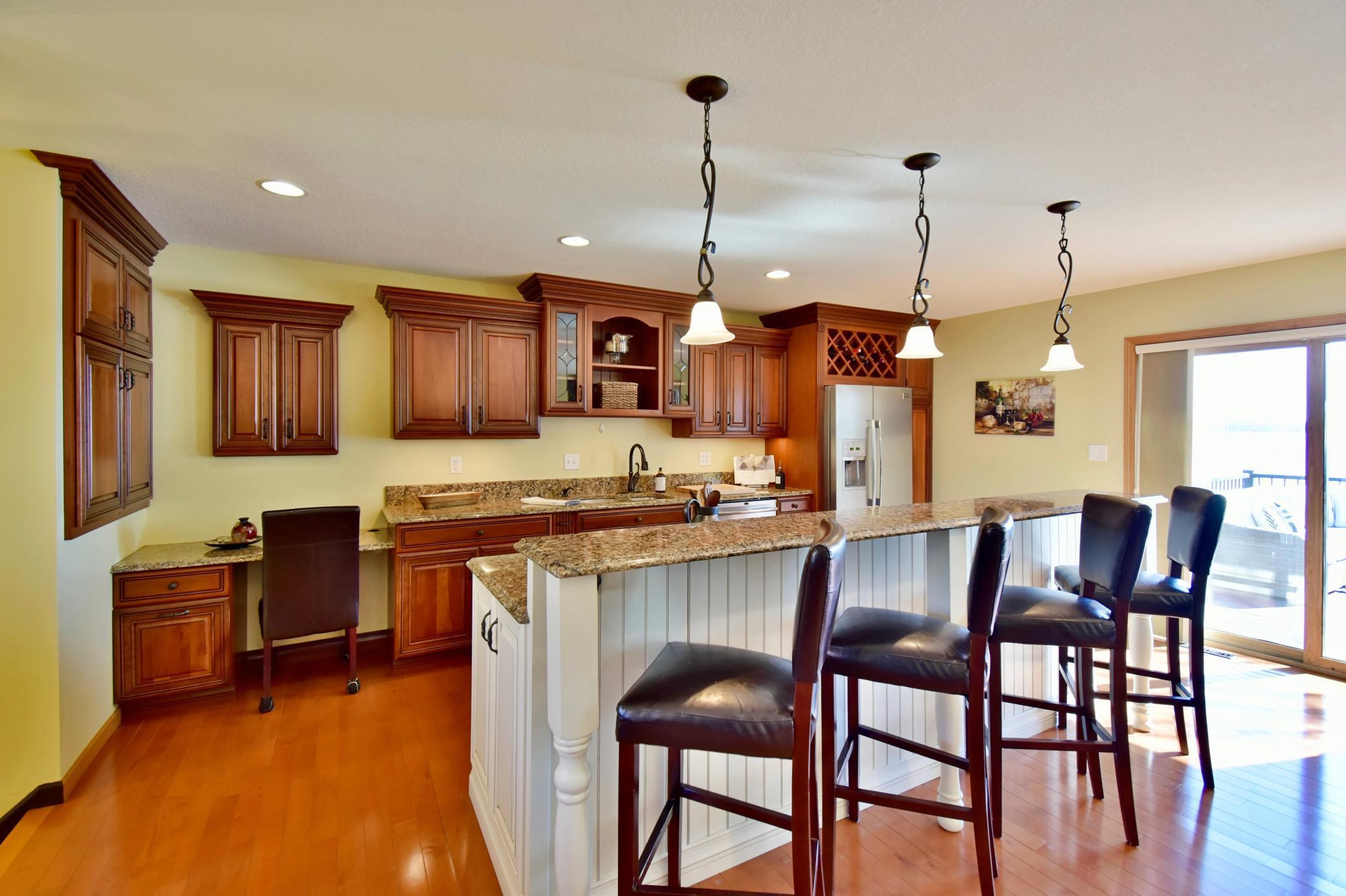 5123 Green Meadow Road SE Osakis, MN 56360 Breakfast bar features a stone surface and a built-in cook top and exhaust.