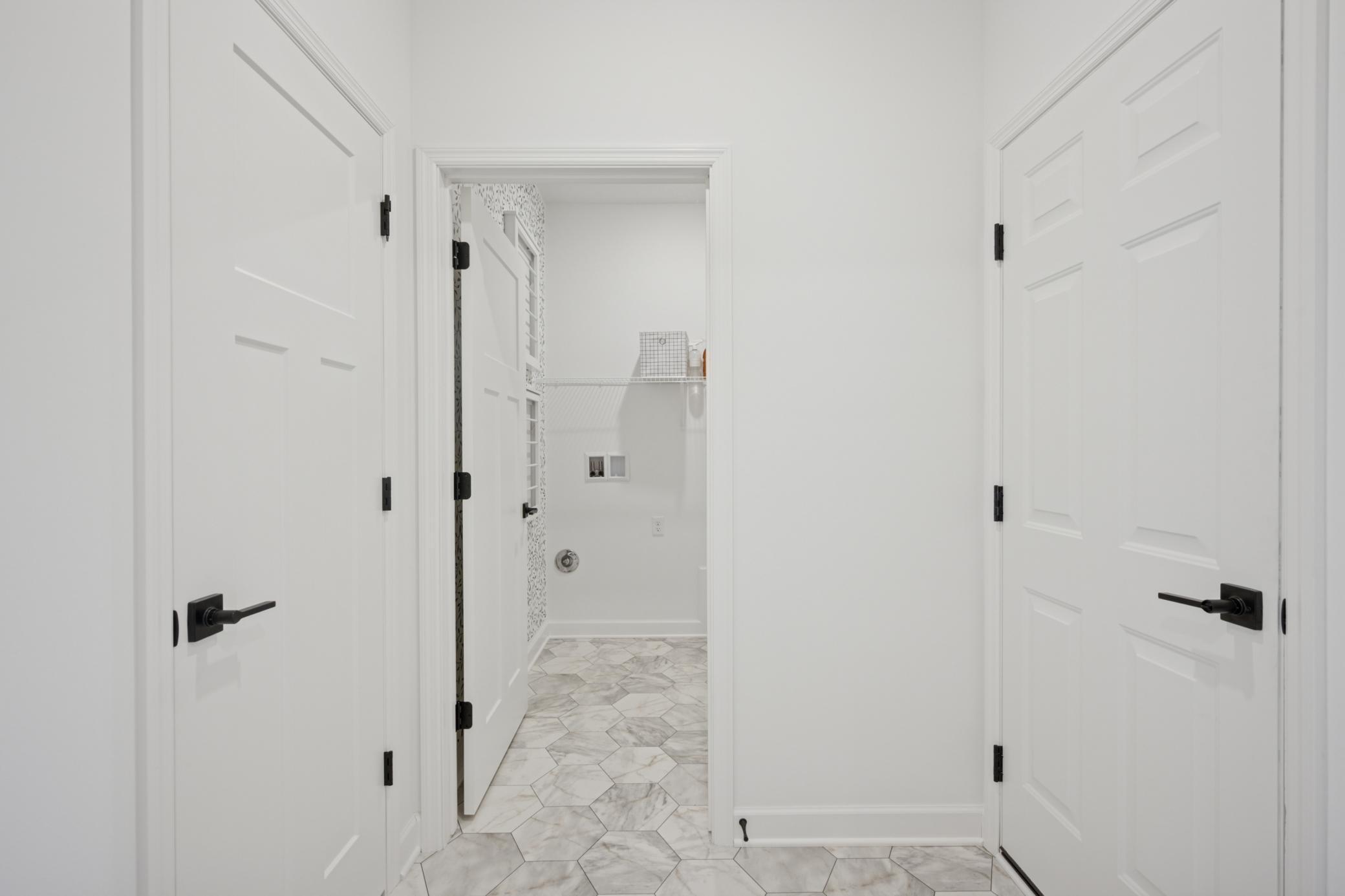 (Photo of a model home, actual finishes may vary) The mudroom conveniently connects to the laundry room and garage.