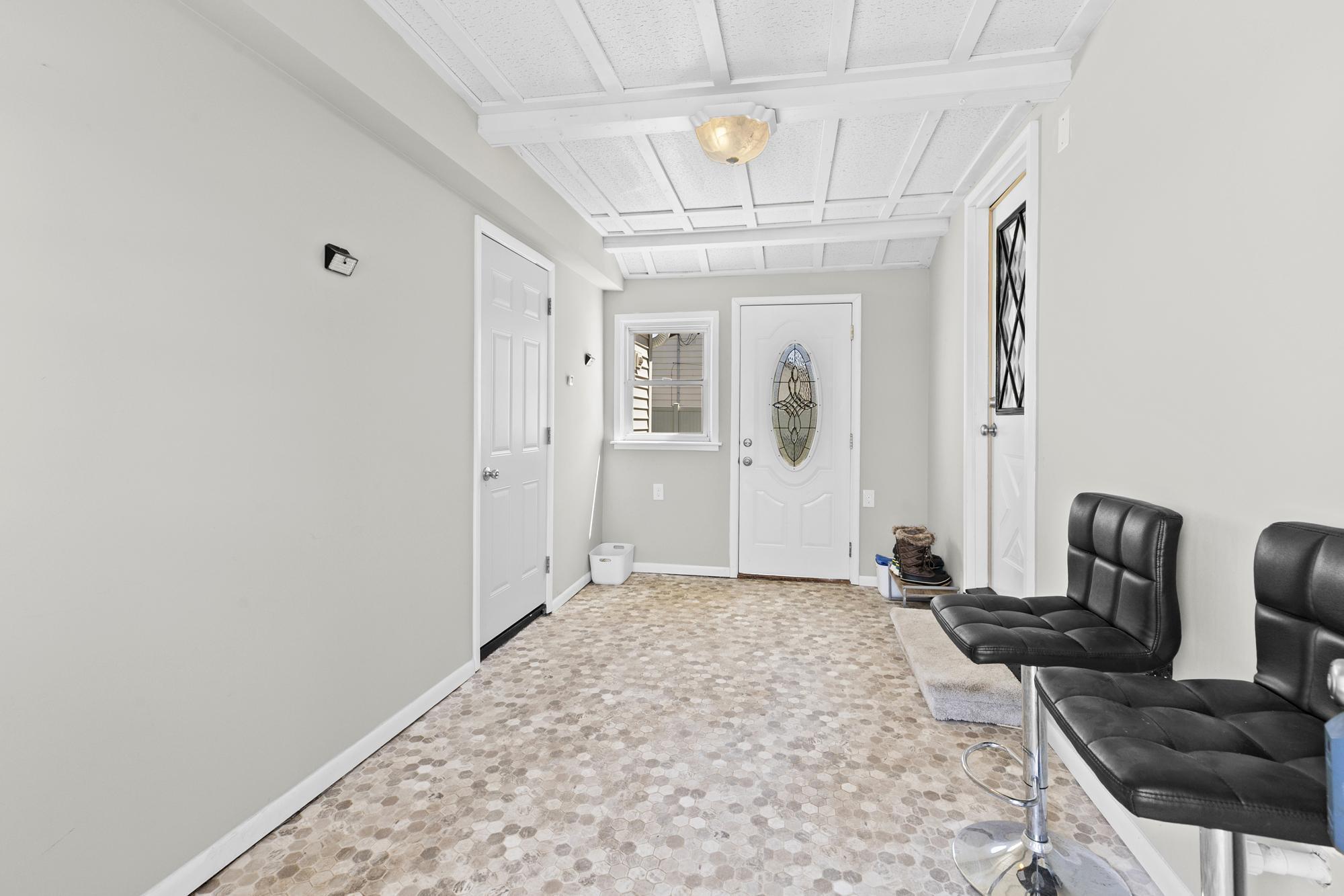 This convenient breezeway provides the perfect transition between the garage and home, offering a great space for a drop zone or mudroom.