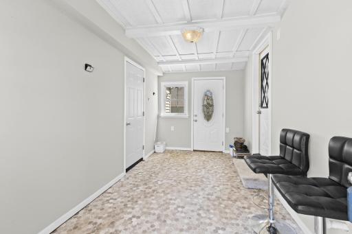 This convenient breezeway provides the perfect transition between the garage and home, offering a great space for a drop zone or mudroom.