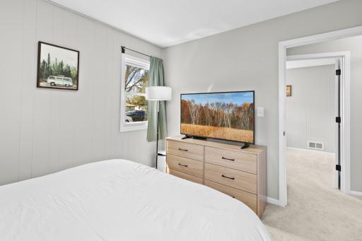 An alternate angle of the primary bedroom with natural lighting.