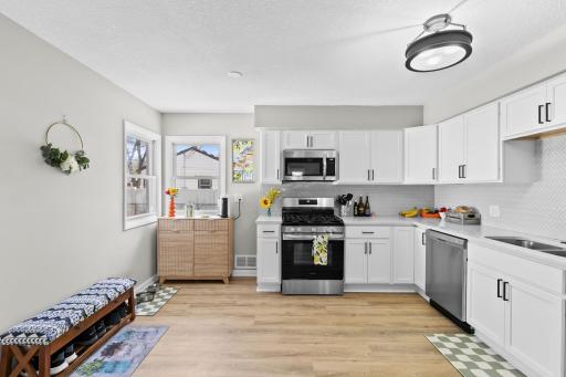 Durable, modern LVP flooring flows beautifully through the kitchen. The layout offers plenty of versatile counter space, perfect for setting up your own morning coffee bar station!