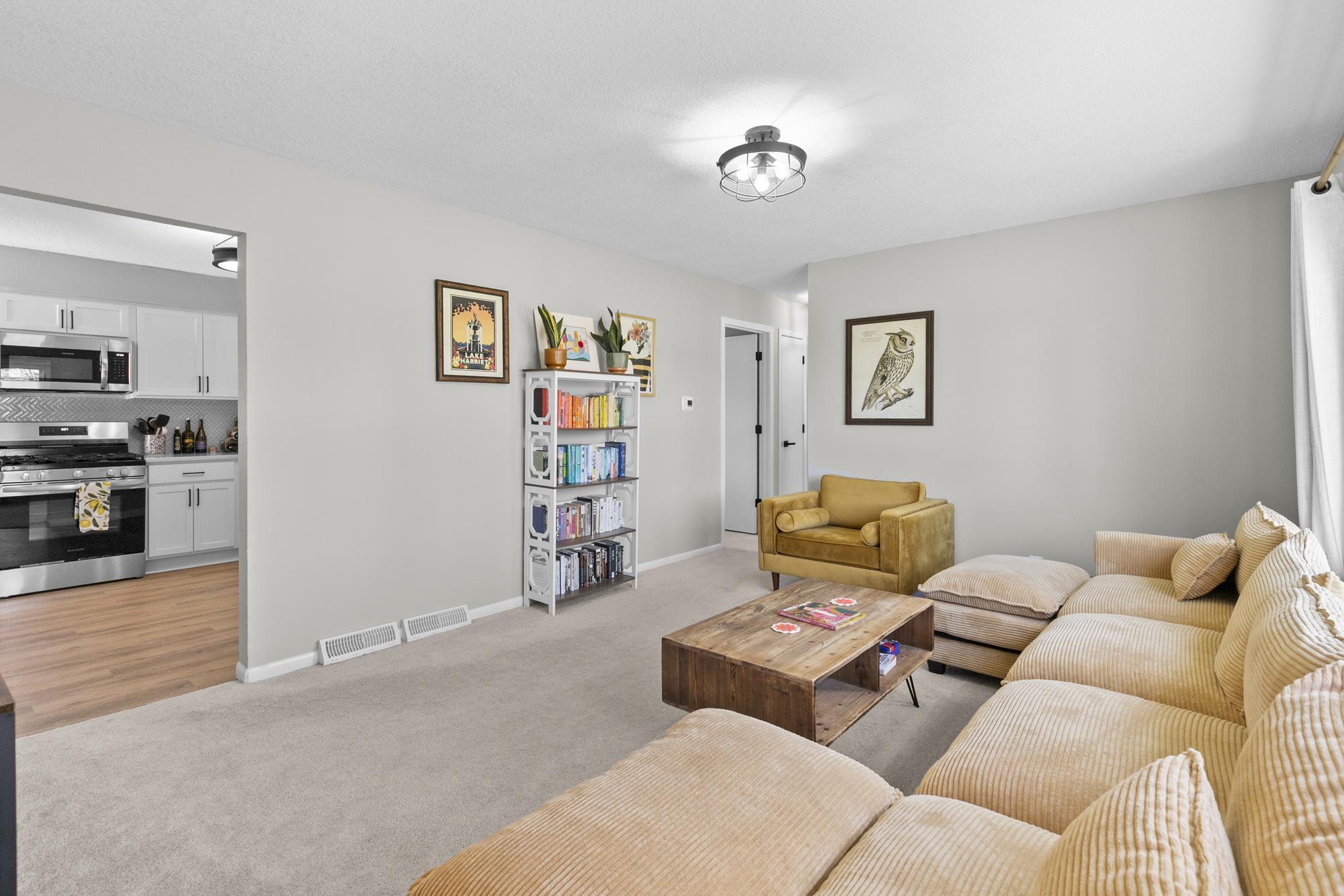 Relax in this bright and inviting living room that flows seamlessly into the beautifully updated kitchen.