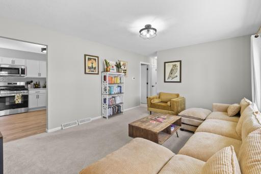 Relax in this bright and inviting living room that flows seamlessly into the beautifully updated kitchen.