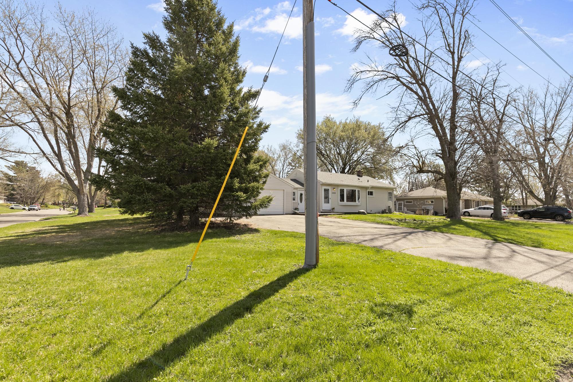 This wide-angle view highlights the generous outdoor space and privacy this corner lot provides.