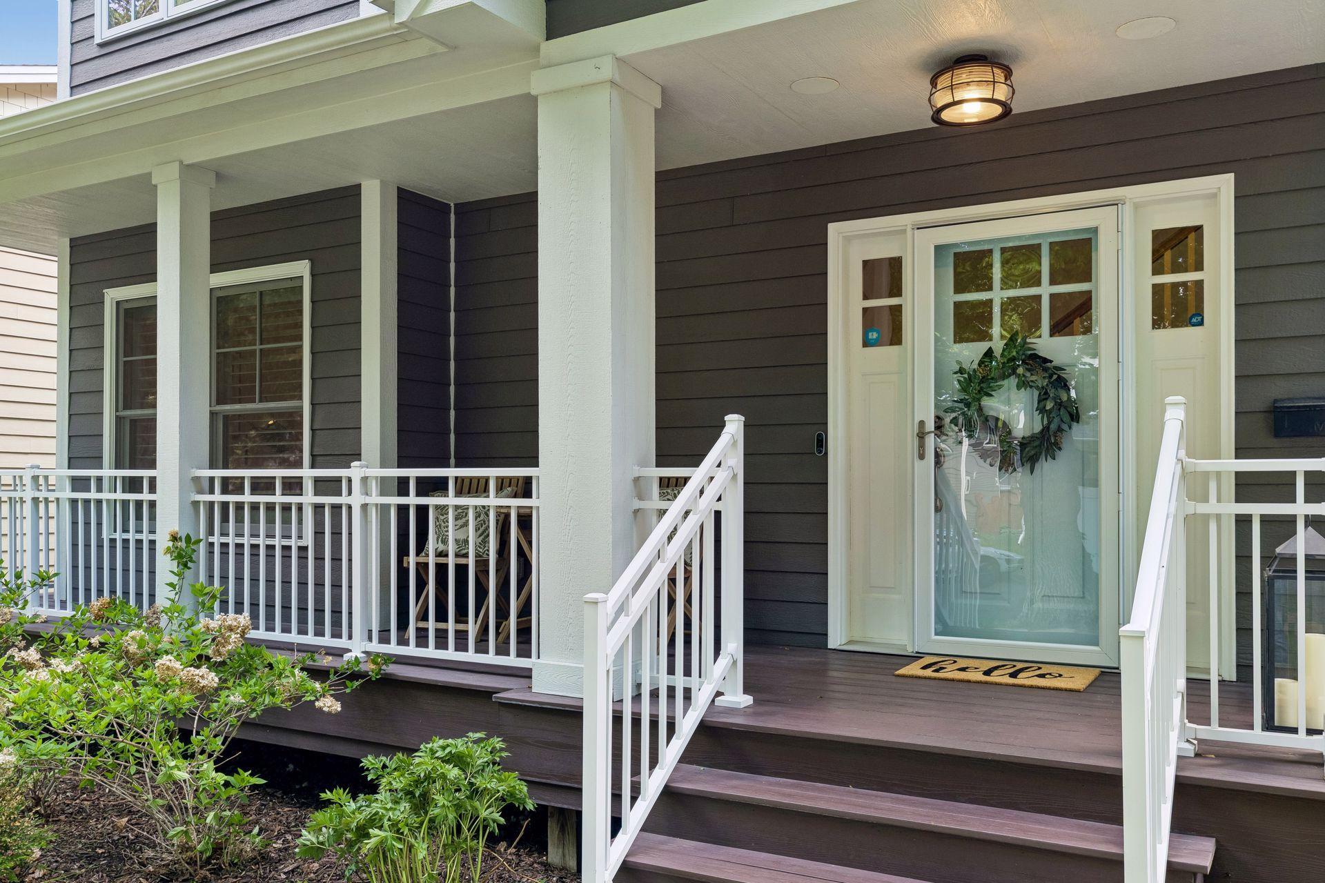Inviting covered front porch, with ring doorbell and keyless deadbolt lock.