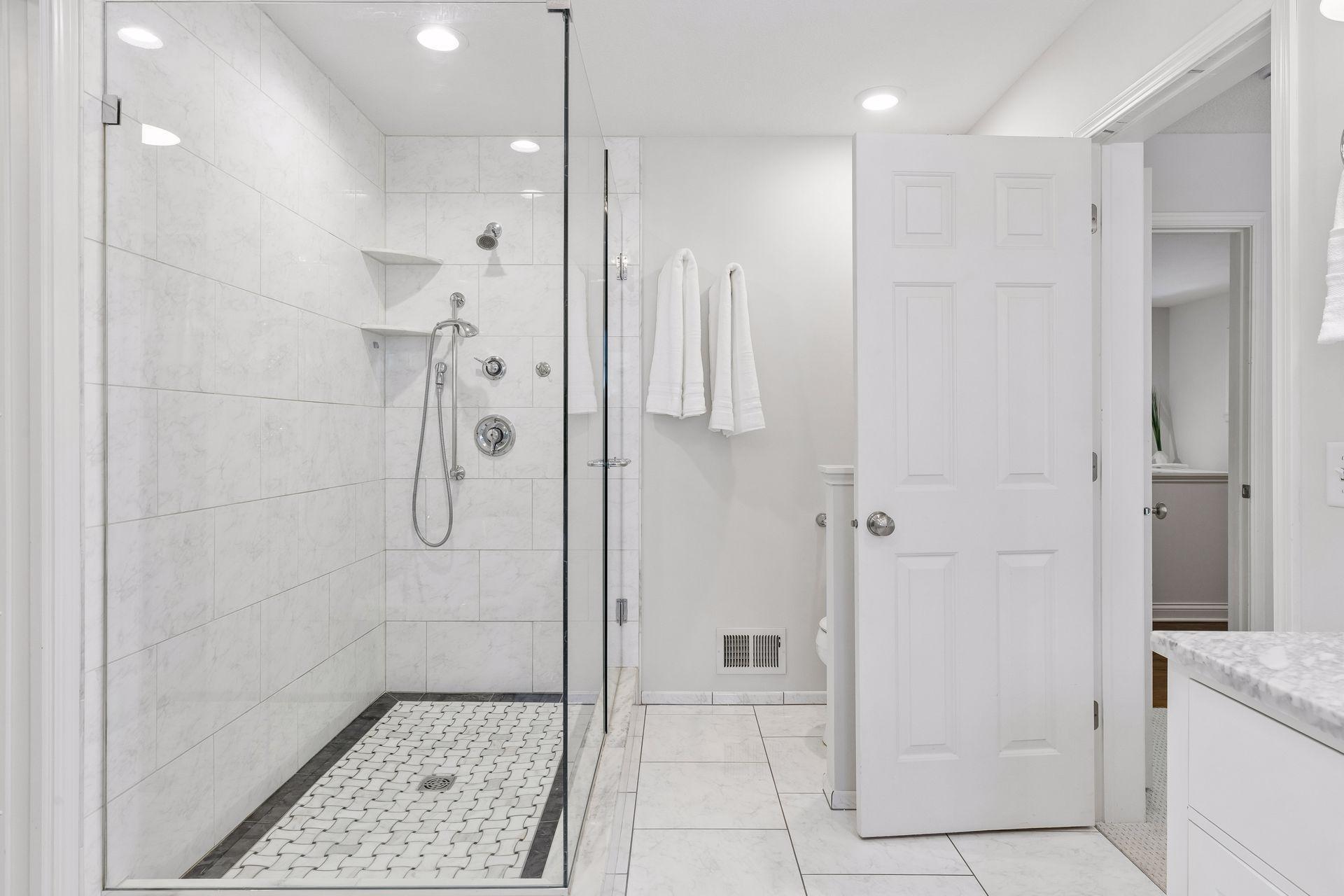 Large glass shower surround in primary ensuite.