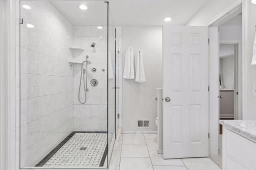 Large glass shower surround in primary ensuite.