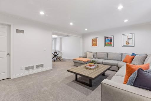 The lower level was remodeled in 2021, with the sixth bedroom wall removed to create a more spacious family room with adjacent wet-bar room.