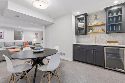 Game area with custom wet-bar and mini fridge.