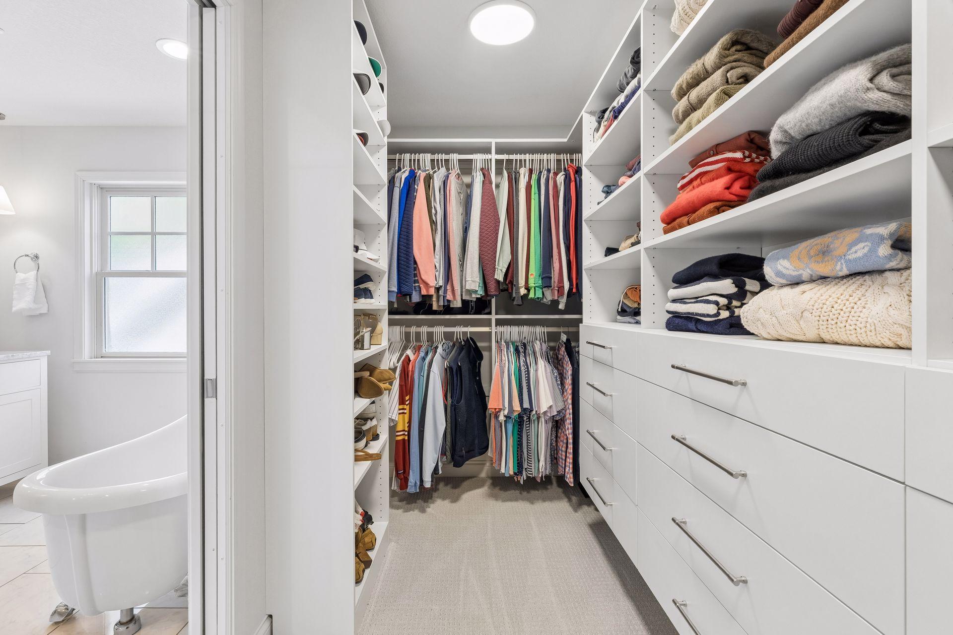 Primary suite walk-in closet with custom California Closet system, and brand new carpet.