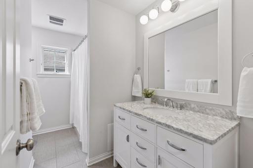 Full bathroom upstairs, with beautiful marble-top vanity.