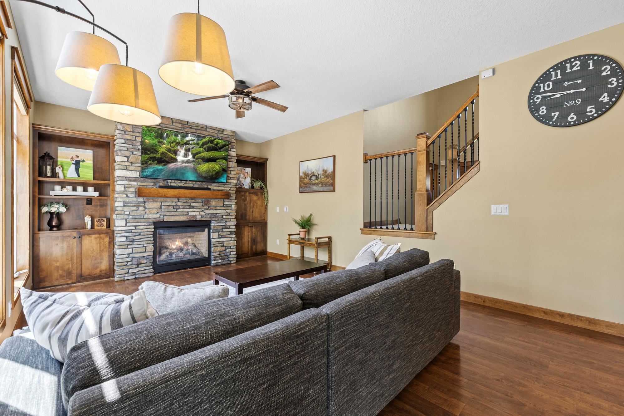 Maple built-ins bookending stone gas fireplace