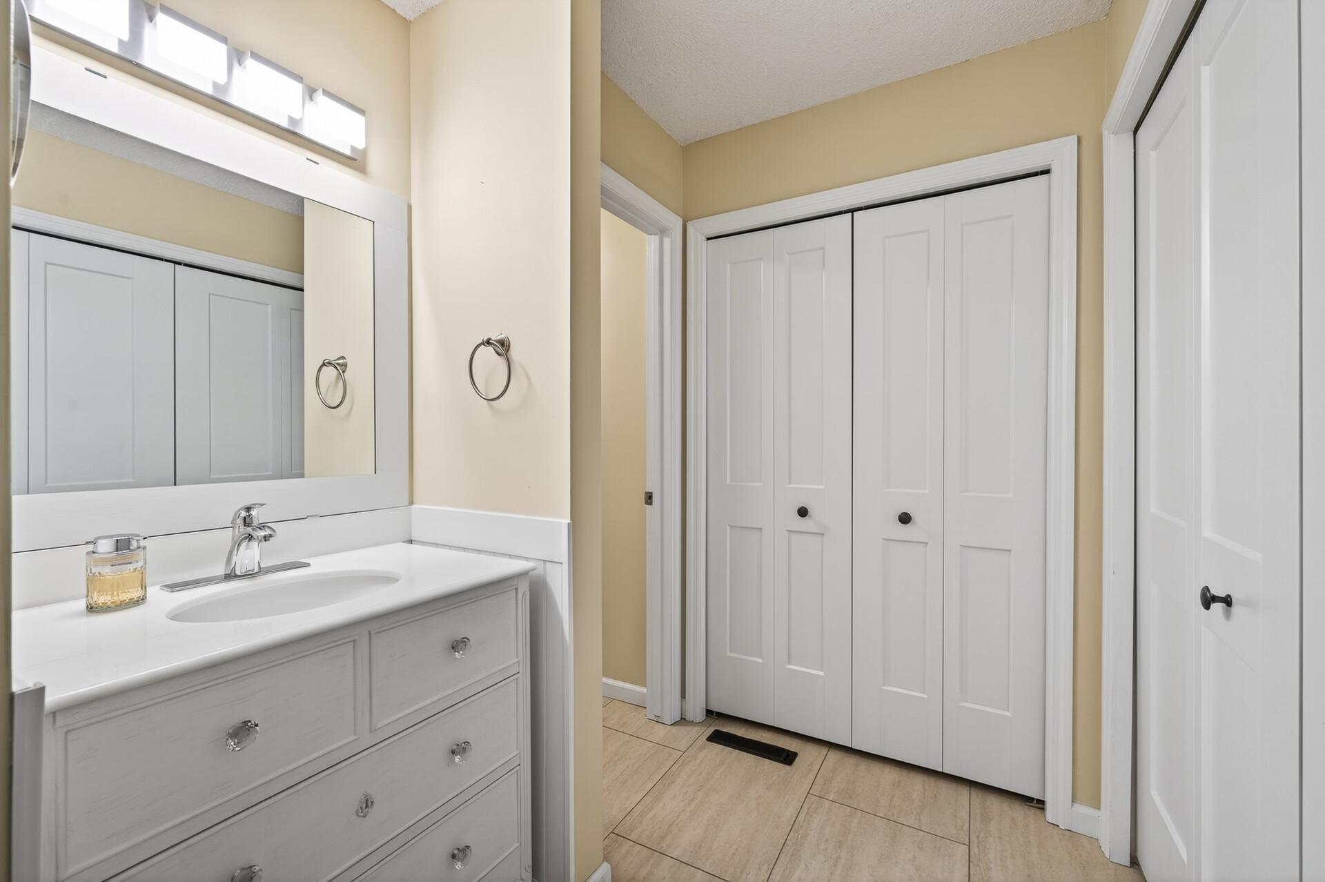Upperlevel full bath with large closet and tile floors.