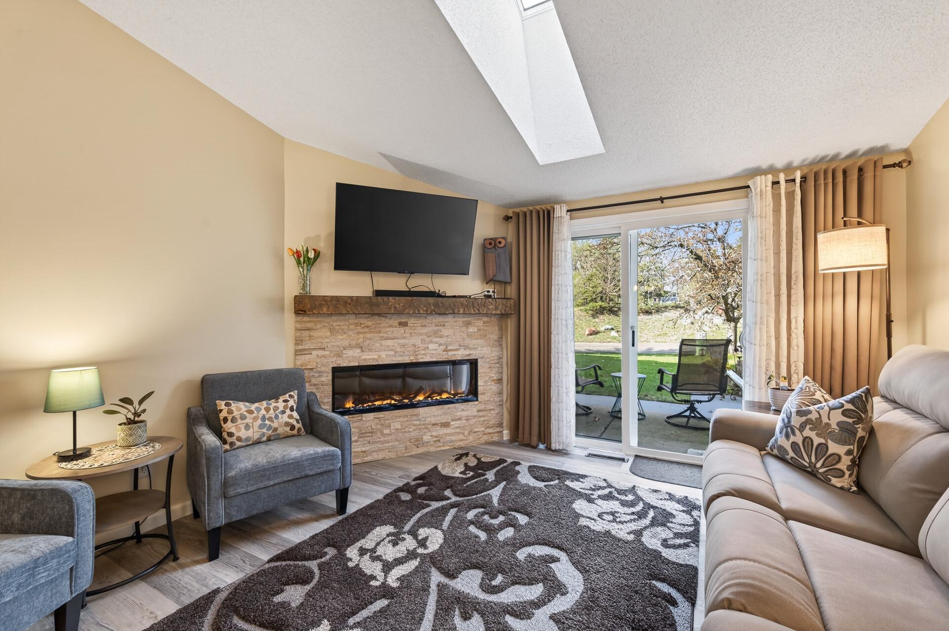 Sun drenched family room with vaults and skylight. Sliding glass doors lead to patio.