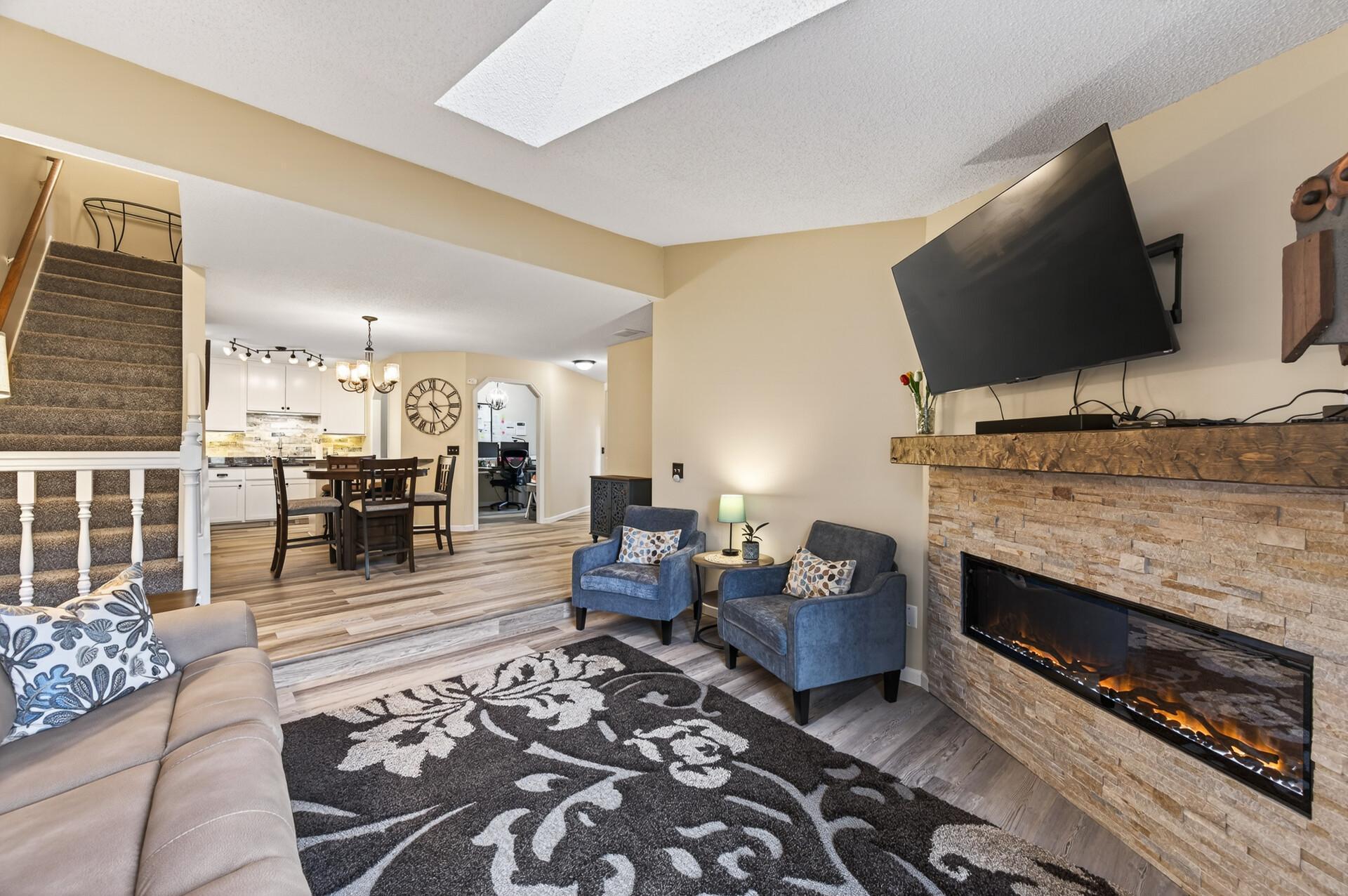 Step down family room with brick surround fireplace.