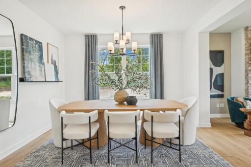 (Photo of model home, finishes will vary) Fit for casual weekend brunches and upscale celebrations alike, the formal dining space joins seamlessly with the Great Room for additional entertaining options.