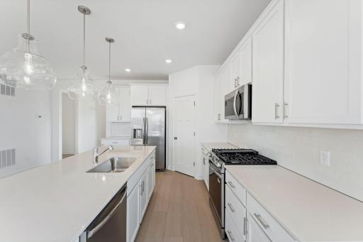 The center island has an open line of sight to the Great Room and dining room in an ideal set-up for modern living