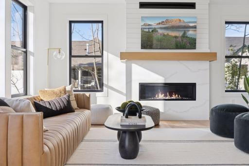 Quartz and shiplap linear fireplace will catch an eye in this beautiful living room