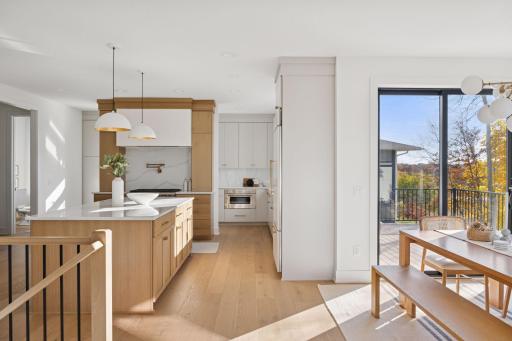 The open-concept main level is ideal for everyday life and entertaining, featuring a spacious kitchen with custom cabinets, a perfect Pantry/Scullery, and a large island.
