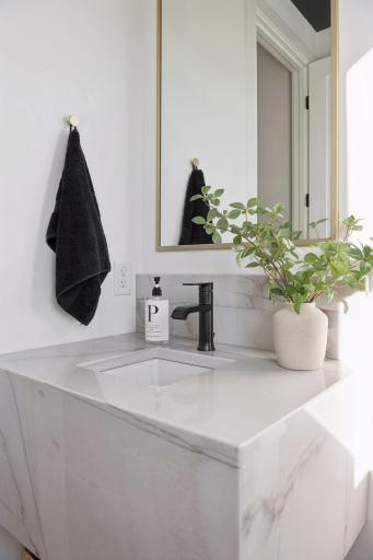 Main level powder bathroom with quartz vanity