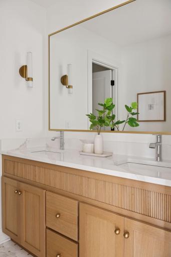 Main bath with reeded decoration on vanity and framed mirror