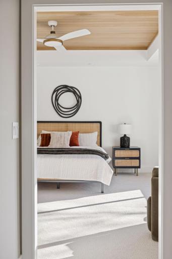 Primary retreat with box vault ceiling detail and large windows for plenty of natural light, overlooking mature trees