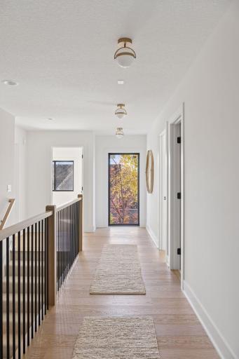 Upper hallway with natural light from the Andersen windows, and eng. hardwood floors