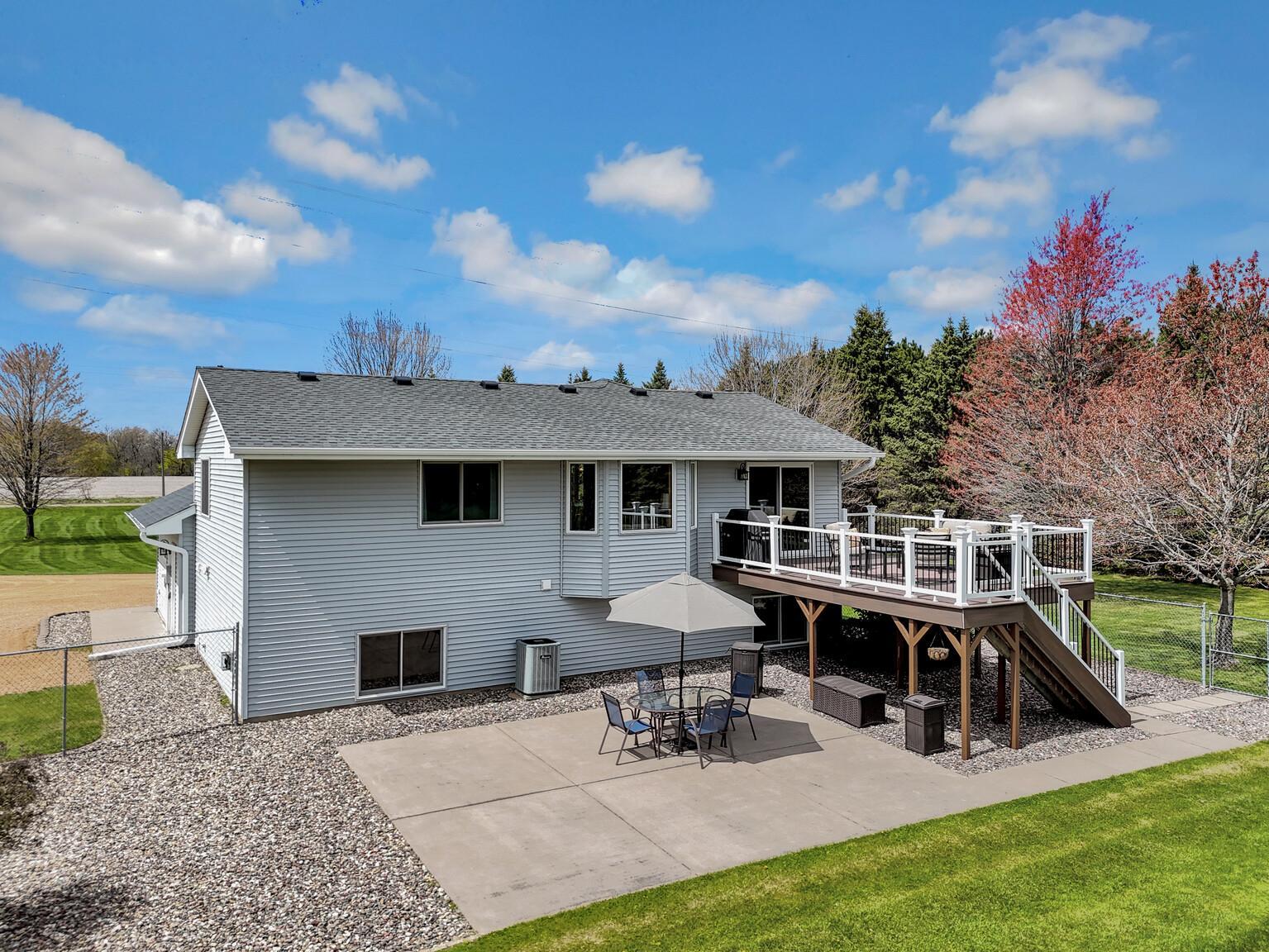 Maintenance free deck descending to a 24 x 20 concrete patio