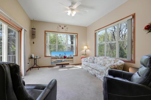 The 4 season sun porch is one of the favorite spots in the home. Three walls of windows brings in great light and beautiful view of the trees out back.
