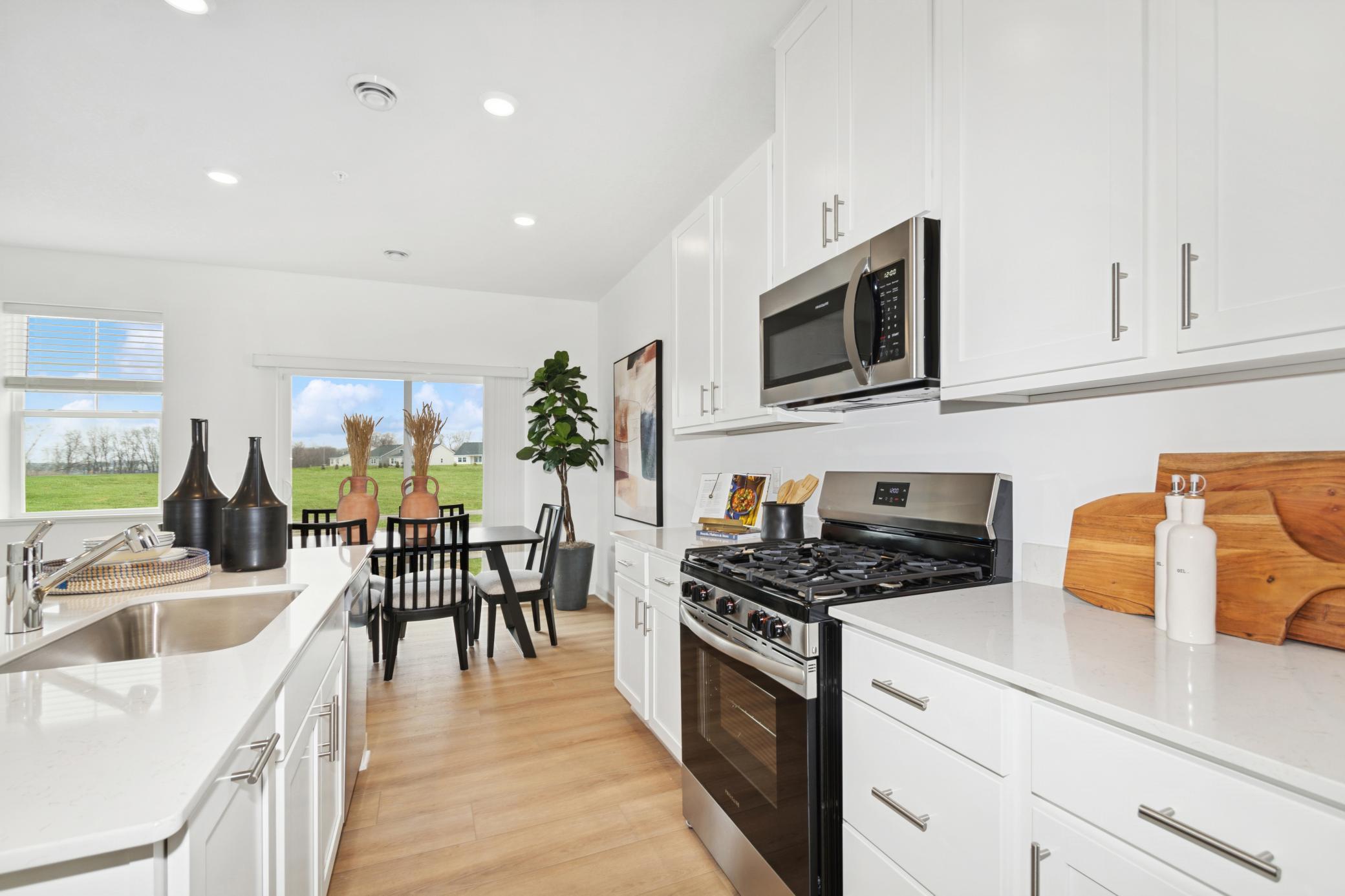 (Photo of model home, features will vary) This center island includes a stainless steel sink with designer faucet to remove stubborn stains