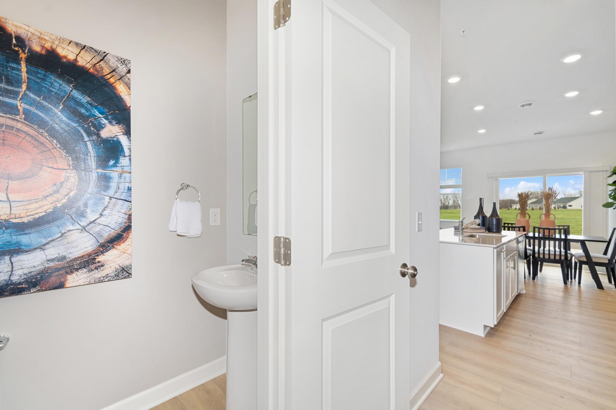 (Photo of model home, features will vary). Situated directly off the kitchen, this powder room optimizes the first-floor main living area for residents and guests alike.
