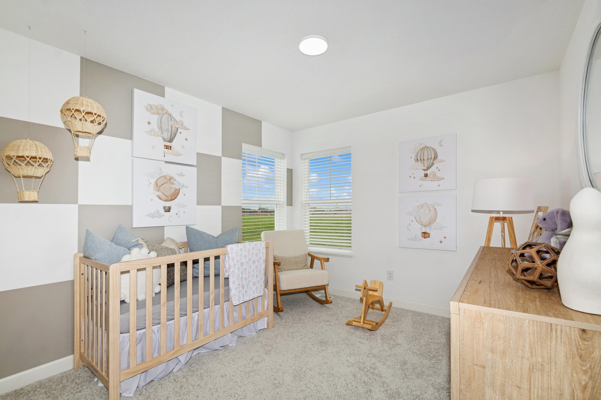 (Photo of model home, features will vary) The upper-level secondary bedrooms are perfectly situated away from the downstairs main living areas and are blank canvases ready to be personalized. Furnished here as a cozy nursery.