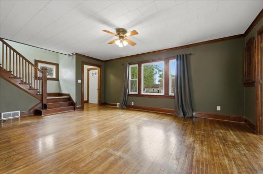 The spacious living room boasts original hardwood flooring & custom built-ins.