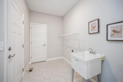Laundry room - photo is of a staged model home with same floorplan