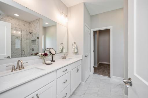 Primary bathroom and walk in closet - photo is of a staged model home with same floorplan