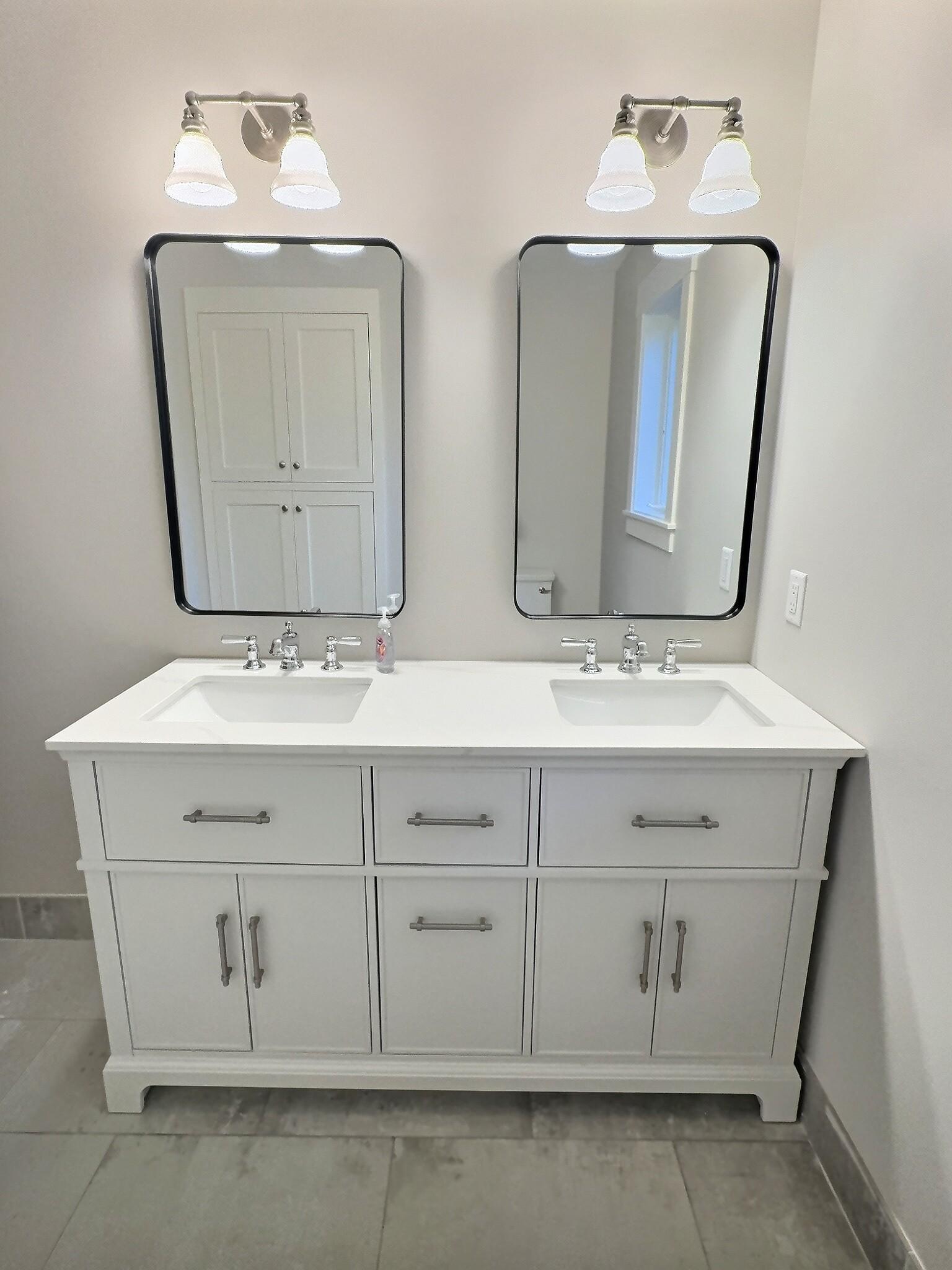Wonderful finishes is both bathrooms the marble countertop blends beautifully with the new lighting and cabinet.