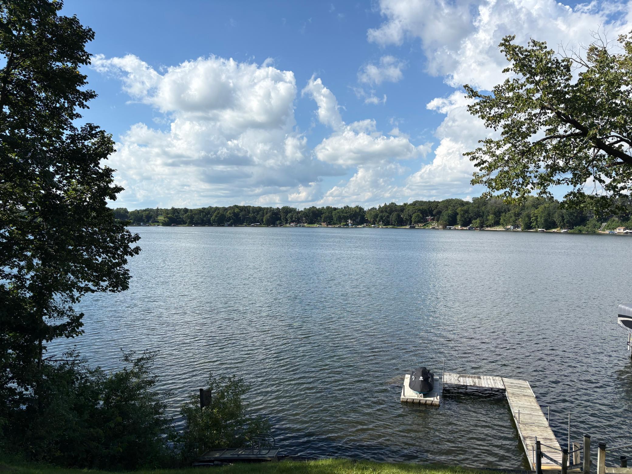 All of this is set on a picturesque, tree-lined lot that offers both privacy and beauty, with mature trees and a serene lakeside setting