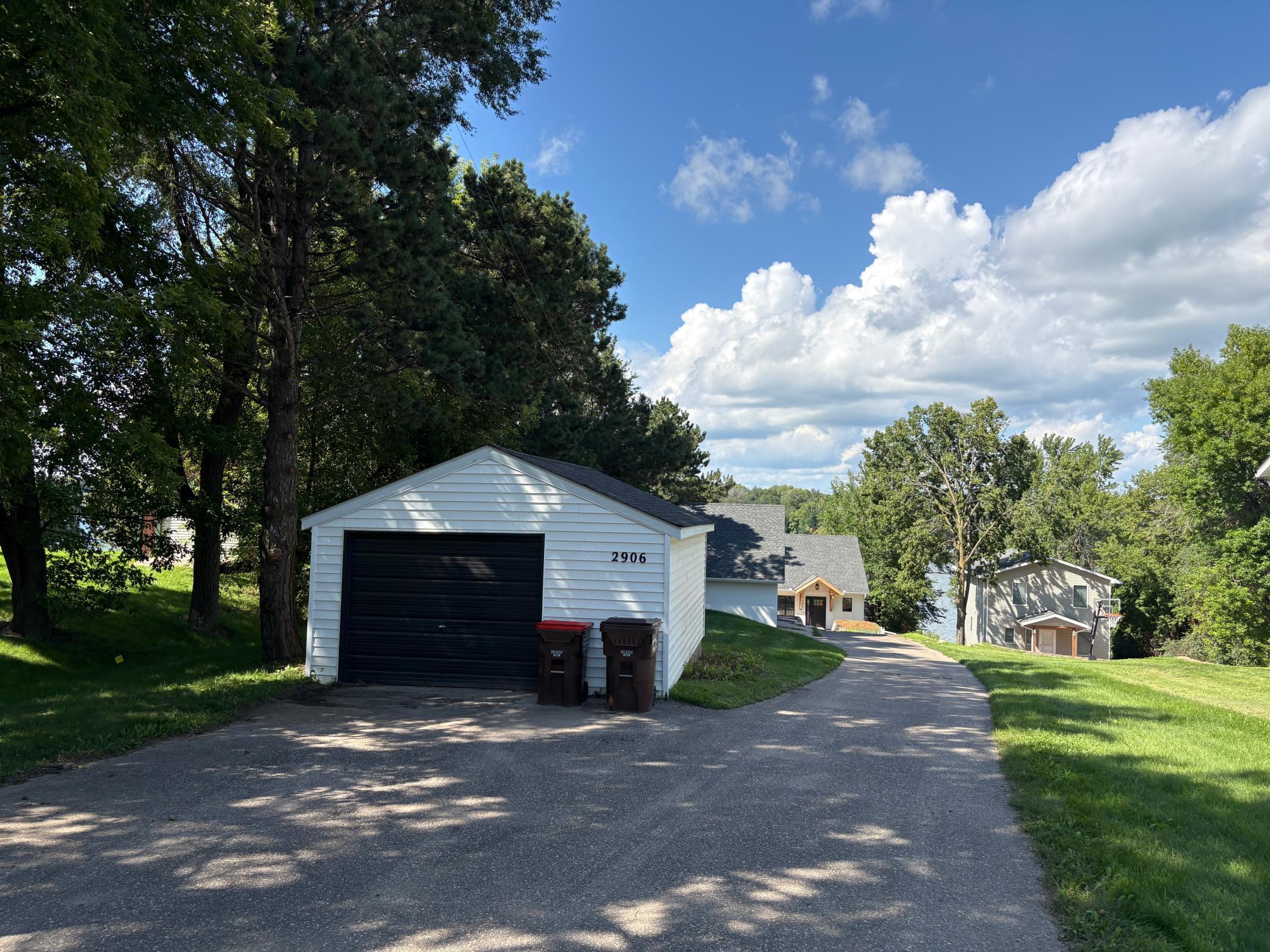 The property includes two detached garages: one smaller garage for your lake toys and a larger, recently finished garage featuring an upper-level bonus space.