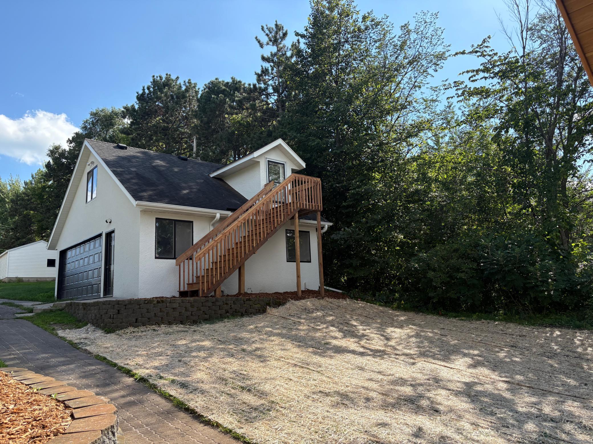 View of the garage showing the staircase going to the bonus room above.