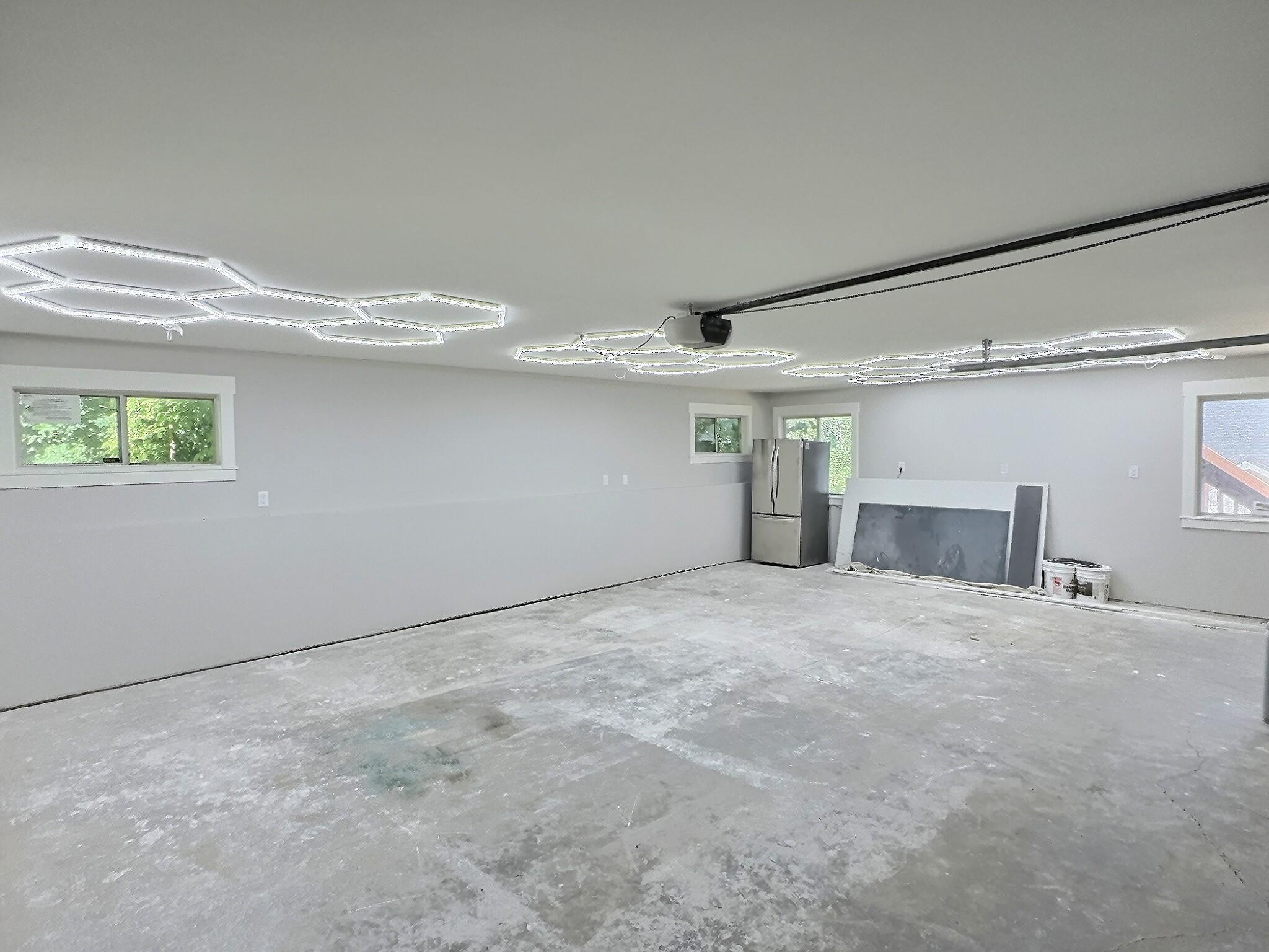 The interior of the garage was recently finished add a heat source and all is complete. New lighting on the ceiling and fridge will stay with the property.