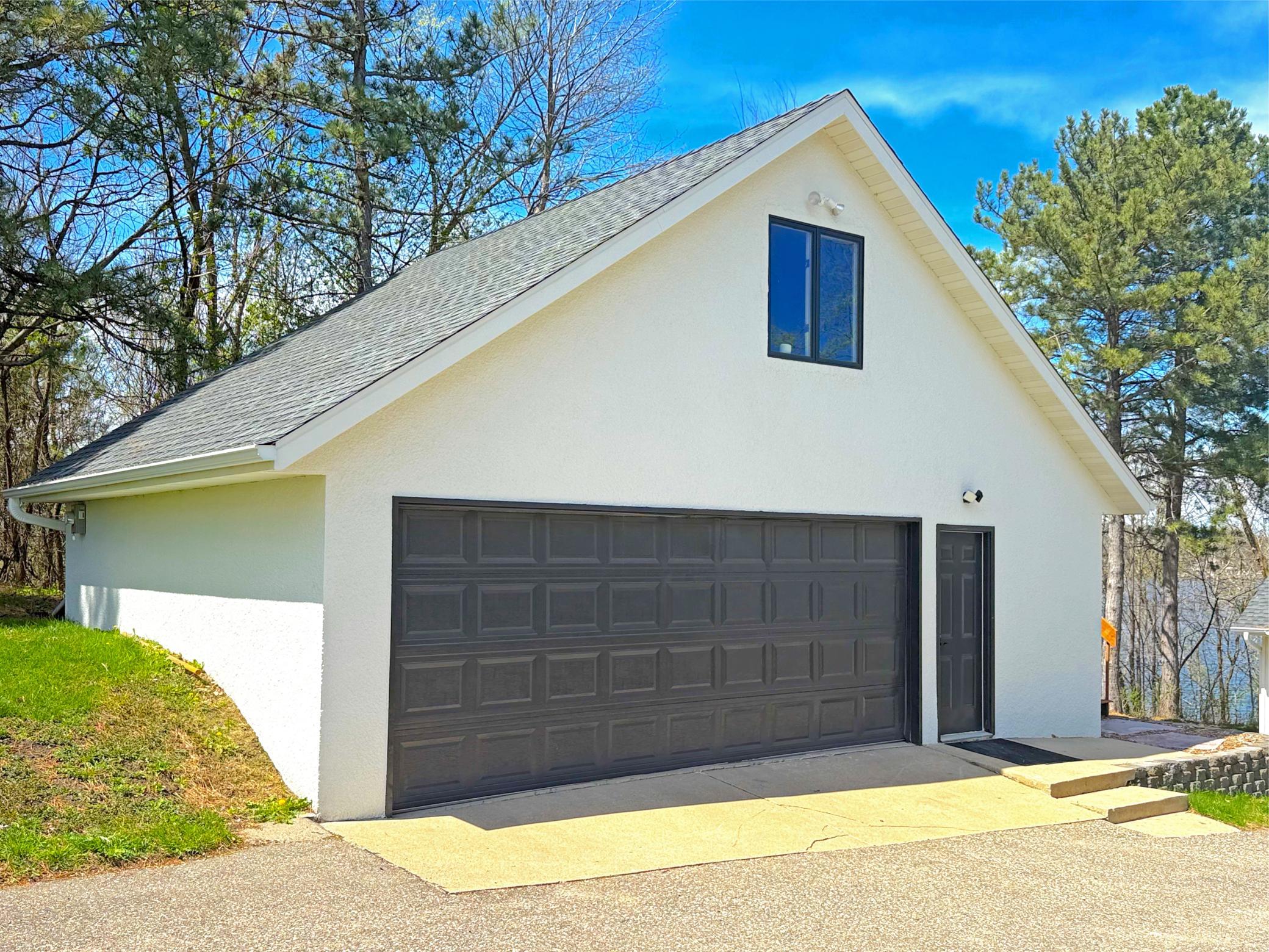 The property has an asphalt driveway that leads to the 2 car detached garage that has a bonus room above. Recent improvements to garage include new gas heater, buried electrical lines to garage and new EV electric meter.