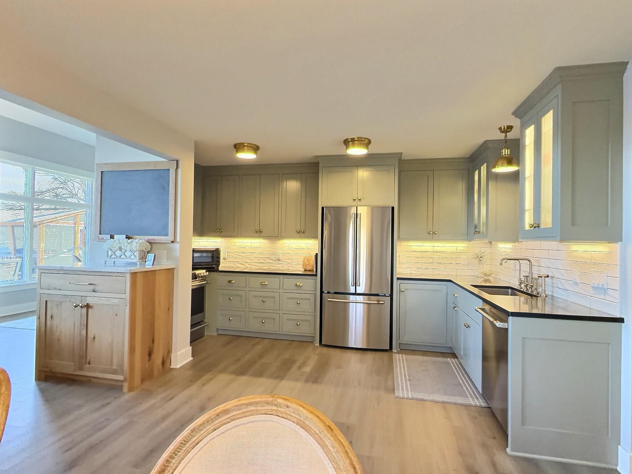 The open-concept on lakeside level boasts an updated kitchen flowing seamlessly into the living room. Notice there is a flex space area off the living room ideal spot for a home office.