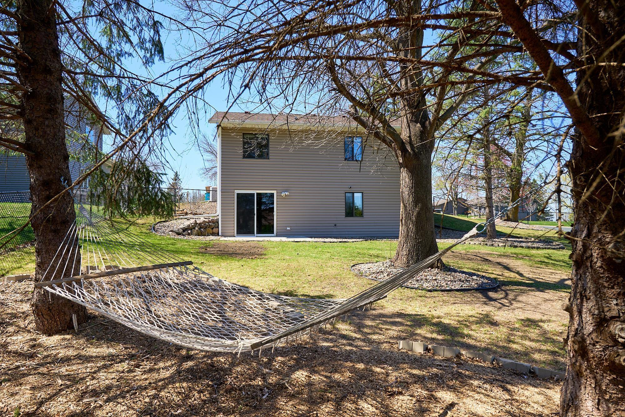 Mature pine trees create a 'hammock haven' in the shaded corner of the yard.